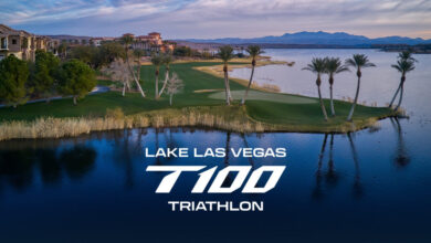 Serene lake view in Las Vegas with palm trees and a lush golf course, promoting the Lake Las Vegas T100 Triathlon event. Stunning landscape perfect for triathlon training and competition.