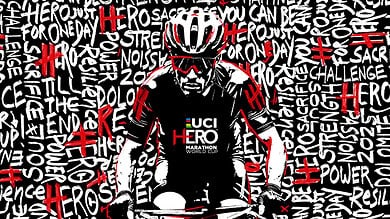 Bike athlete preparing for triathlon race, wearing helmet and sports gear, in front of a colourful background with inspirational words and slogans.