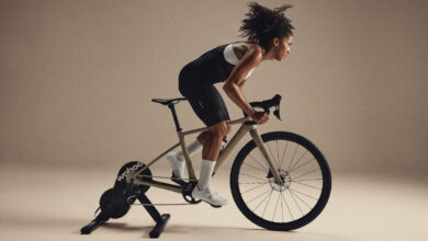 Indoor cycling woman training on smart bike, high-intensity cardio workout for triathlon training, fitness, endurance, athlete performance, and cycling performance.