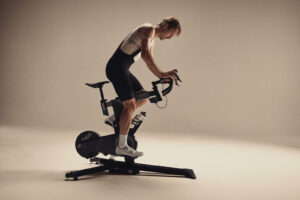 High-performance indoor cycling trainer with a professional cyclist using a Wahoo KICKR smart bike trainer for triathlon training.
