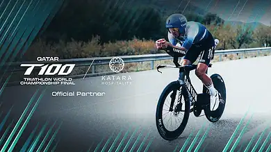 High-performance triathlon cyclist participating in the Qatar T100 Triathlon World Championship Final, showcasing triathlon training and racing strategies, with a focus on endurance and speed.