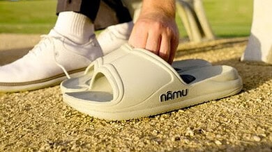 High-performance triathlon shoe on sandy terrain, close-up view showcasing sports gear, ideal for triathlon training and racing, focusing on endurance, speed, and athletic footwear.