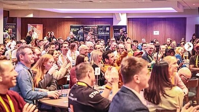 Large audience attending The Running Conference 2026, with engaged participants and event banners in the background.