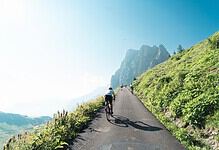 Cyclists climbing a paved mountain road during La Fausto Coppi