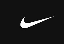 Close-up of the Nike swoosh logo on a black background, representing sportswear and athletic performance.
